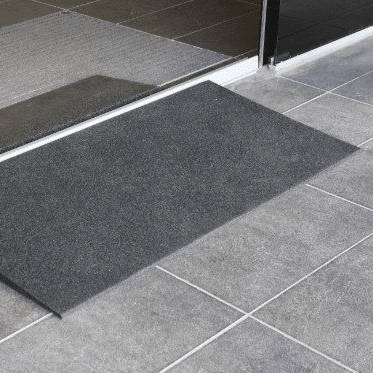 Sliding door rubber threshold ramp Rubber threshold ramp sitting against a sliding glass door track on tiles