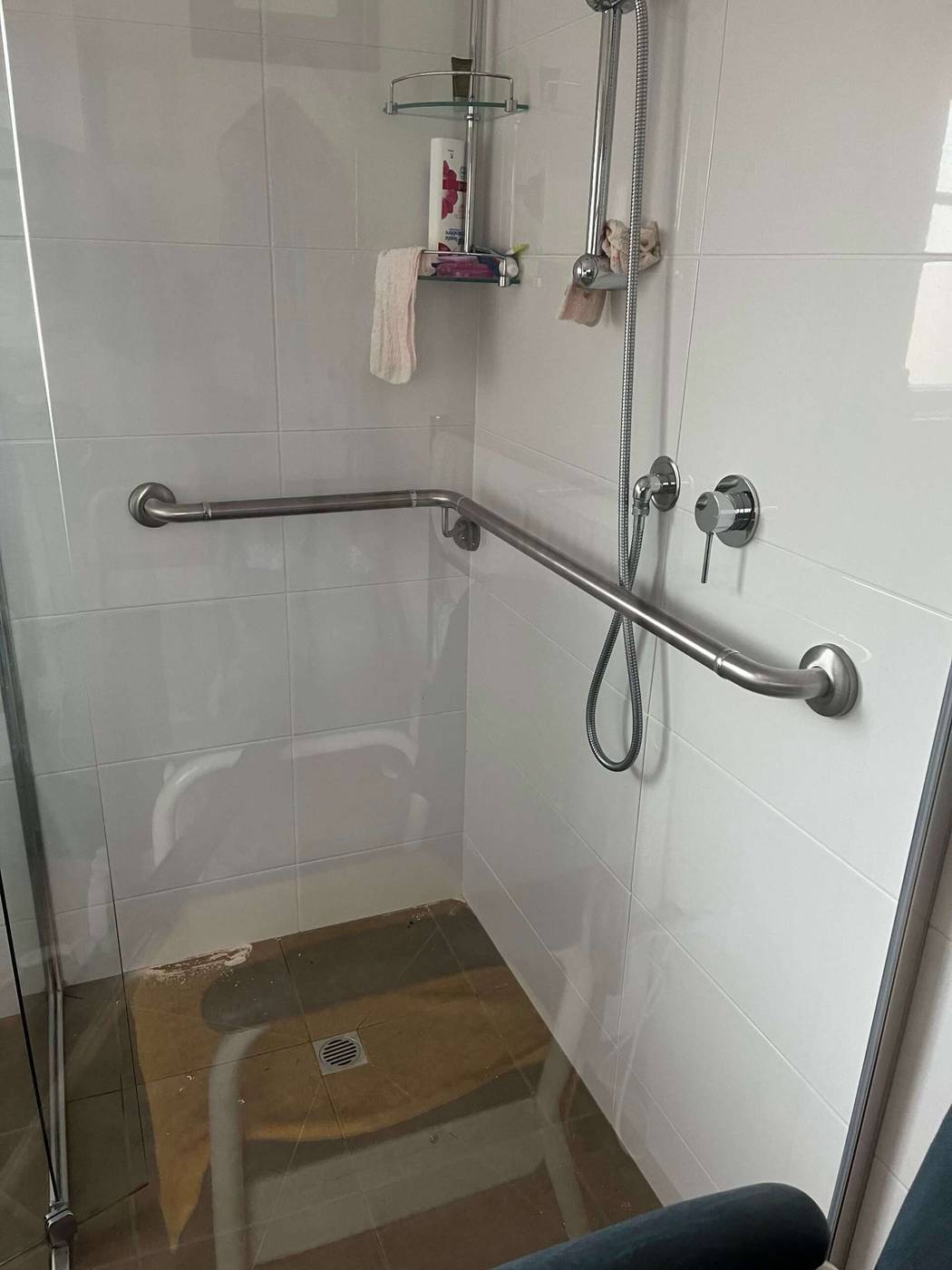 Stainless steel shower grab rails Stainless steel L-shaped grab rails installed in an accessible shower